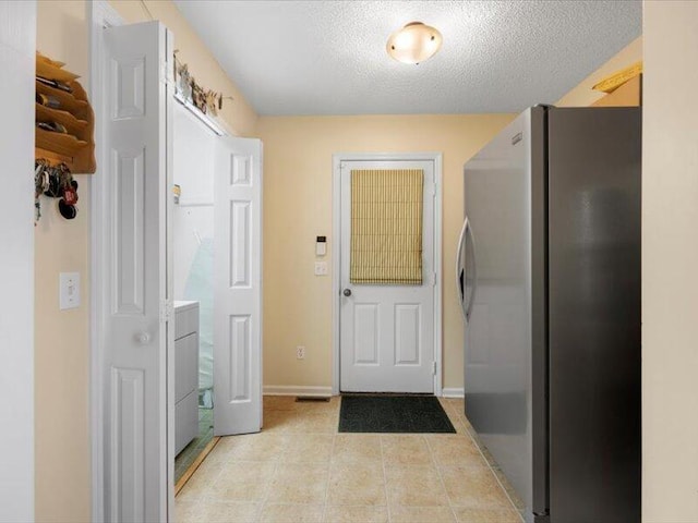 entryway featuring a textured ceiling