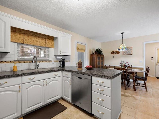 kitchen with dishwasher, kitchen peninsula, white cabinetry, and sink