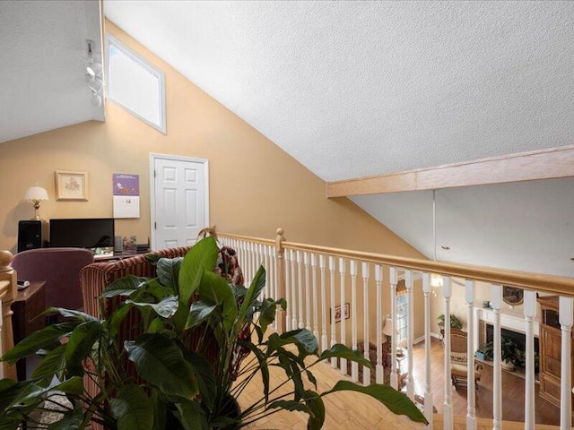 interior space featuring a textured ceiling and lofted ceiling