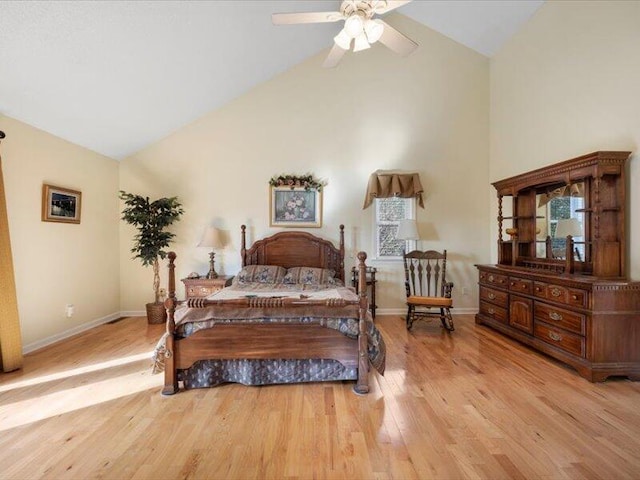 bedroom with ceiling fan, light wood-type flooring, and vaulted ceiling