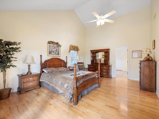 bedroom with light wood-type flooring, high vaulted ceiling, and ceiling fan