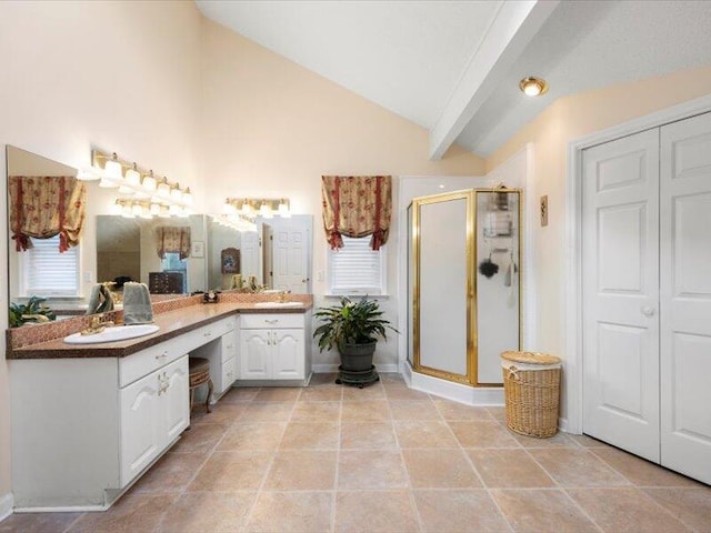 bathroom with tile patterned floors, a shower with door, vanity, and vaulted ceiling