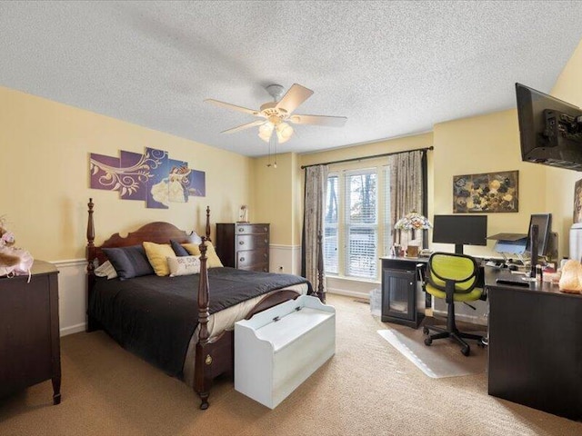 carpeted bedroom featuring a textured ceiling and ceiling fan