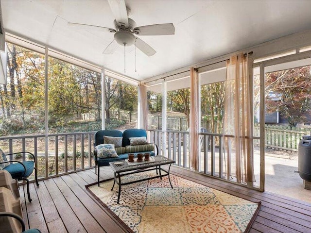 sunroom featuring ceiling fan and plenty of natural light