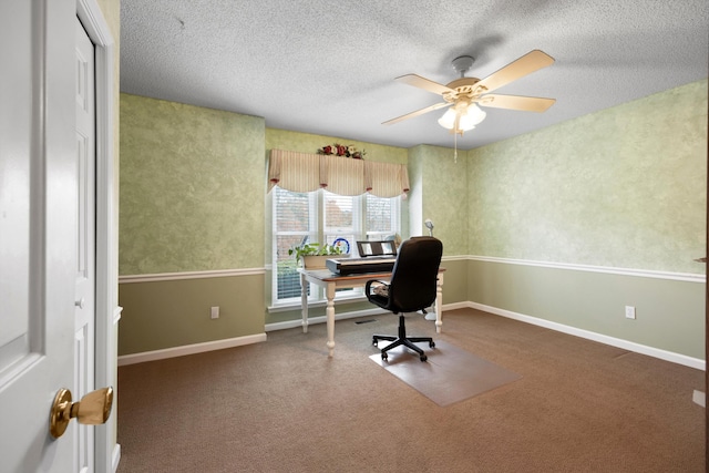 carpeted office with a textured ceiling, ceiling fan, and baseboards