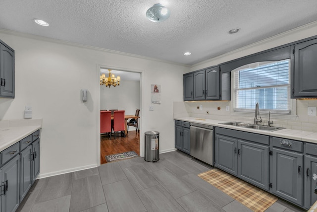 kitchen featuring gray cabinetry, dishwasher, and sink