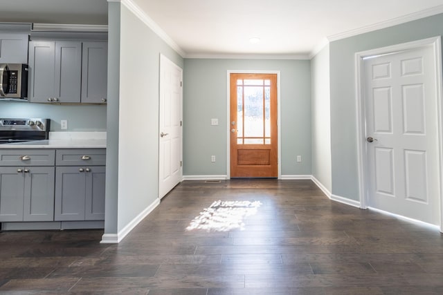 entrance foyer with dark hardwood / wood-style floors and ornamental molding