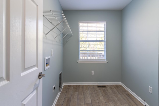 laundry area with electric dryer hookup, washer hookup, and hardwood / wood-style flooring