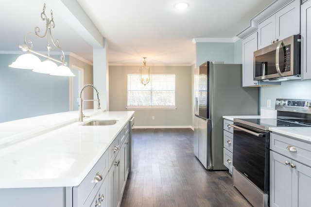 kitchen with gray cabinetry, sink, pendant lighting, a center island with sink, and appliances with stainless steel finishes