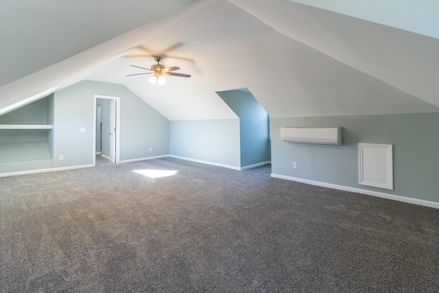 additional living space featuring dark carpet, vaulted ceiling, a wall mounted AC, ceiling fan, and built in features