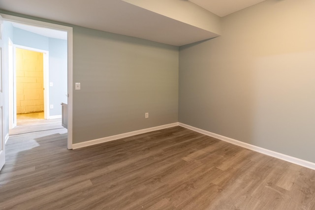 unfurnished room with hardwood / wood-style flooring