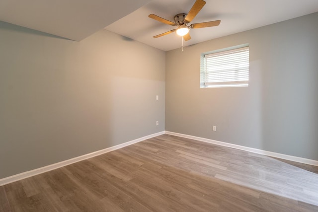 spare room featuring light hardwood / wood-style flooring and ceiling fan