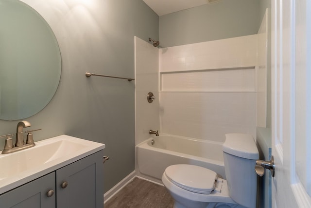 full bathroom with shower / washtub combination, vanity, wood-type flooring, and toilet