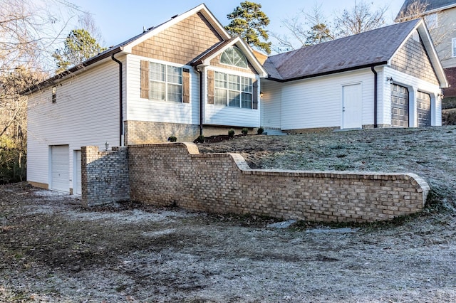 rear view of property featuring a garage