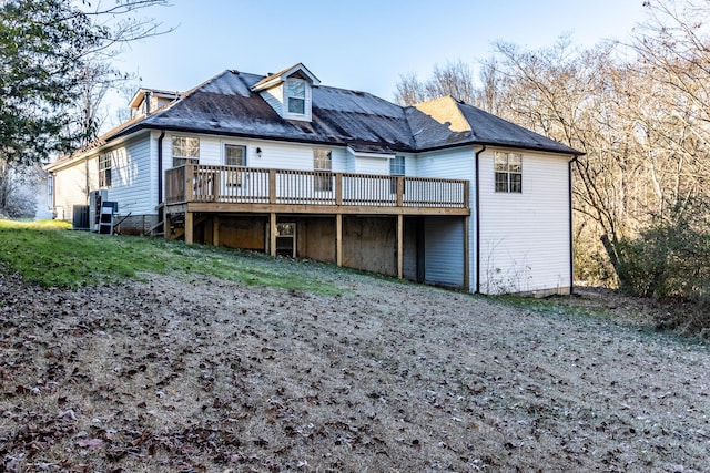 back of property with central AC and a deck