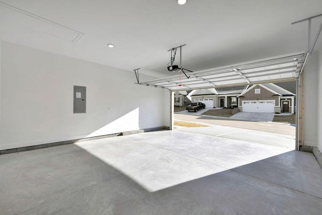 garage with electric panel, baseboards, and a garage door opener