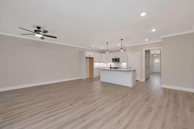 unfurnished living room featuring baseboards, a ceiling fan, crown molding, light wood-type flooring, and recessed lighting