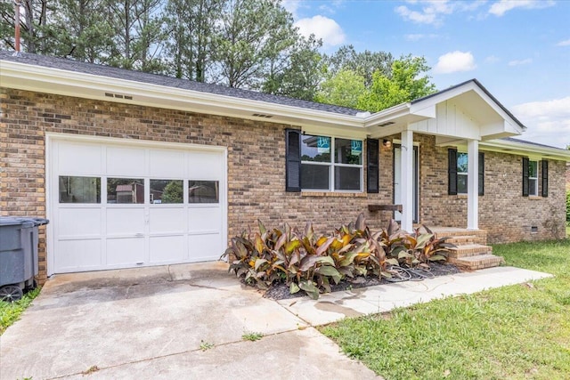 ranch-style home featuring brick siding, an attached garage, and driveway