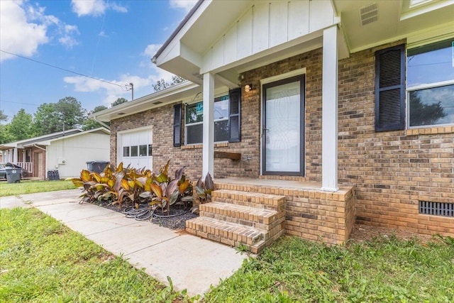 doorway to property with brick siding