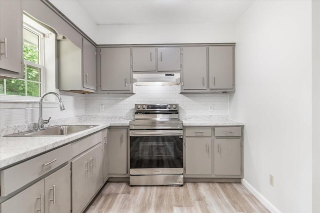 kitchen with stainless steel electric stove, gray cabinets, and a sink