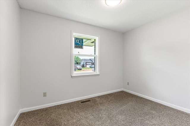 carpeted empty room with baseboards