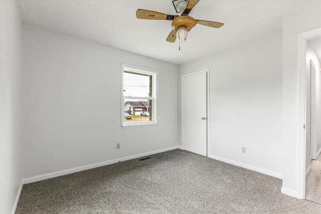 unfurnished bedroom featuring carpet, baseboards, and ceiling fan