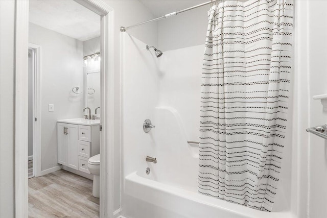 bathroom featuring shower / bath combination with curtain, vanity, wood finished floors, and toilet