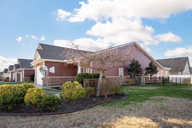 view of home's exterior featuring a lawn and cooling unit