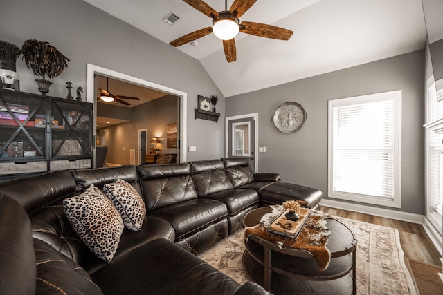 living room featuring hardwood / wood-style flooring, ceiling fan, and lofted ceiling