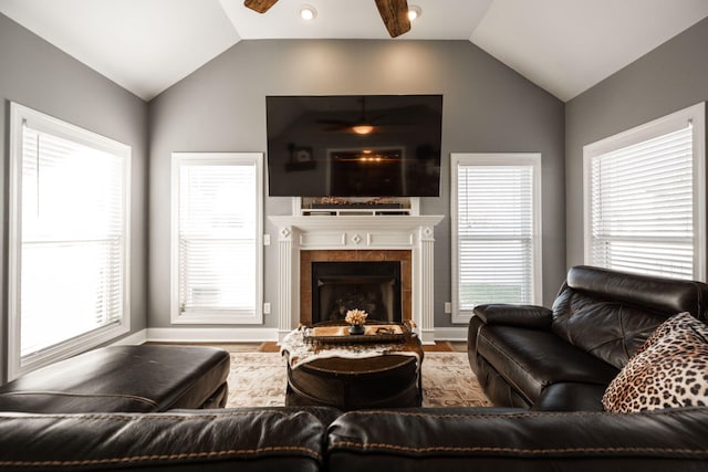 living room featuring a fireplace, hardwood / wood-style flooring, ceiling fan, and lofted ceiling