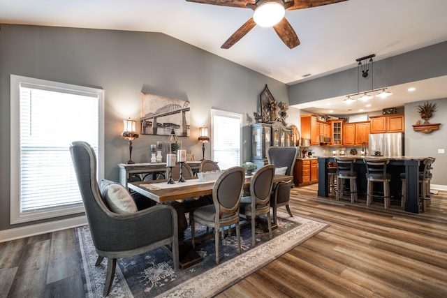 dining space with ceiling fan, dark hardwood / wood-style flooring, and lofted ceiling