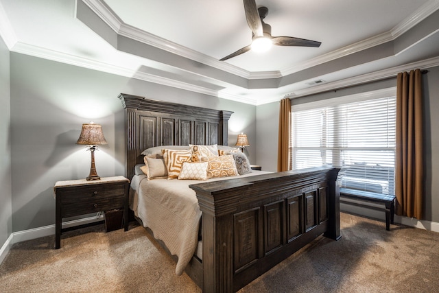 carpeted bedroom featuring ceiling fan, ornamental molding, and a tray ceiling