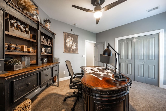 carpeted home office with ceiling fan