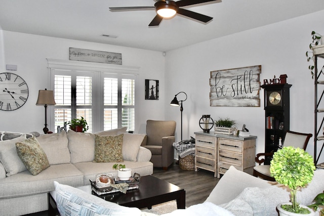 living room featuring dark hardwood / wood-style flooring and ceiling fan