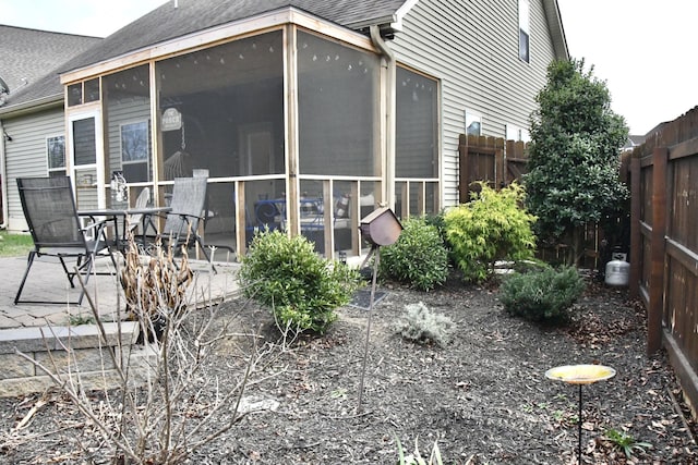 back of house with a sunroom and a patio area