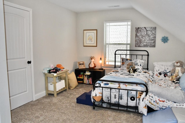 bedroom with carpet flooring and lofted ceiling