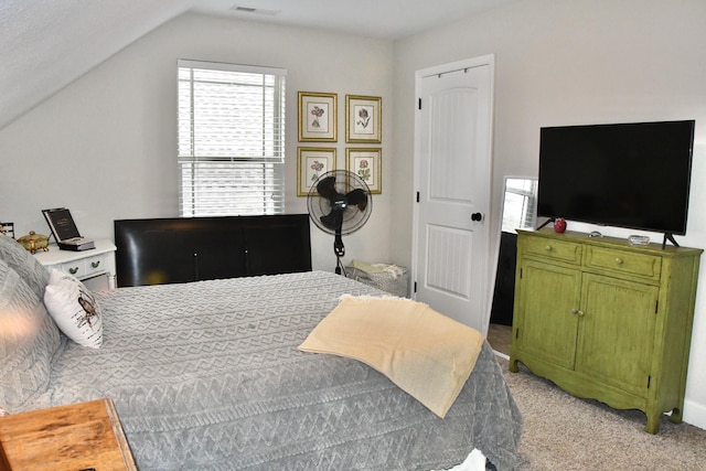 bedroom with light colored carpet and vaulted ceiling