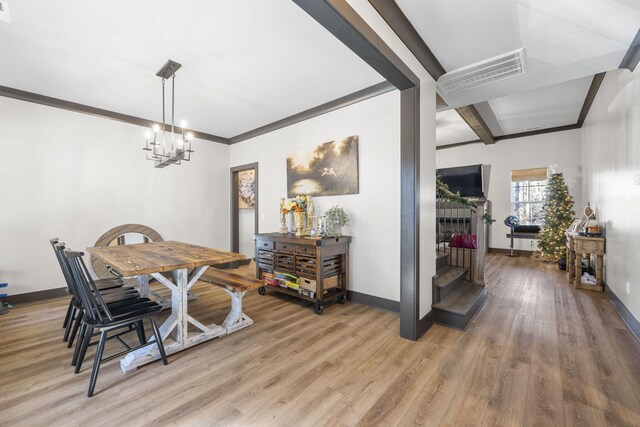 dining area featuring hardwood / wood-style floors and an inviting chandelier