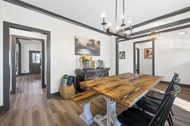 dining space featuring dark hardwood / wood-style flooring and a notable chandelier