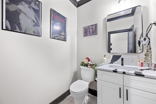 bathroom with tile patterned flooring, vanity, and toilet