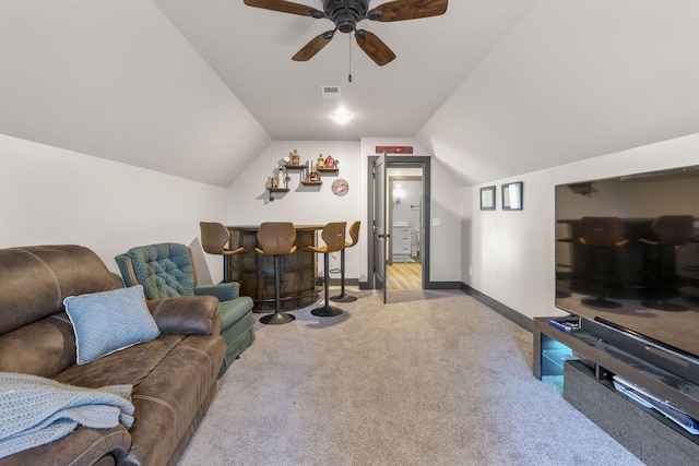 carpeted living room with ceiling fan, lofted ceiling, and bar