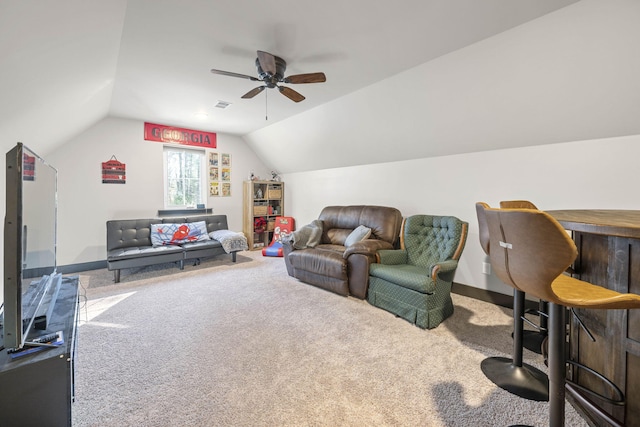 carpeted living room featuring vaulted ceiling and ceiling fan