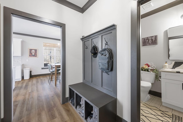 mudroom with light hardwood / wood-style floors