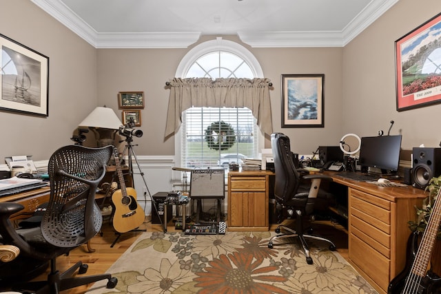 home office with ornamental molding and light hardwood / wood-style flooring