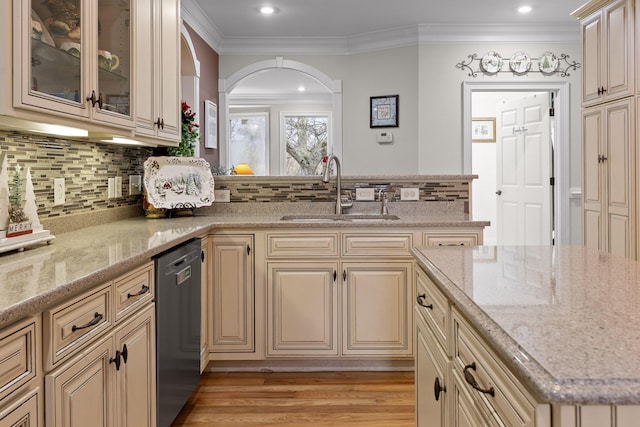 kitchen with light stone countertops, sink, tasteful backsplash, stainless steel dishwasher, and ornamental molding