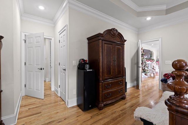 sitting room with ornamental molding and light hardwood / wood-style flooring