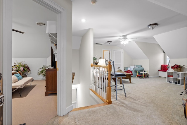 additional living space with ceiling fan, light colored carpet, and lofted ceiling