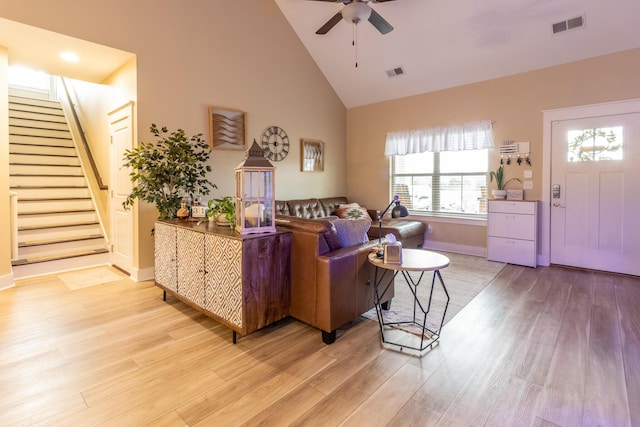 living room with high vaulted ceiling, light hardwood / wood-style flooring, and ceiling fan