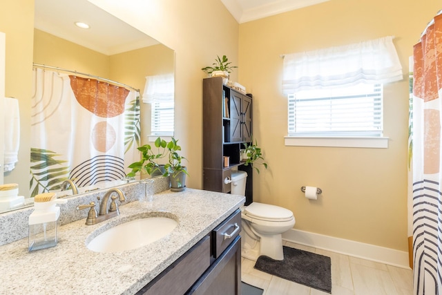 bathroom with tile patterned floors, vanity, crown molding, and toilet