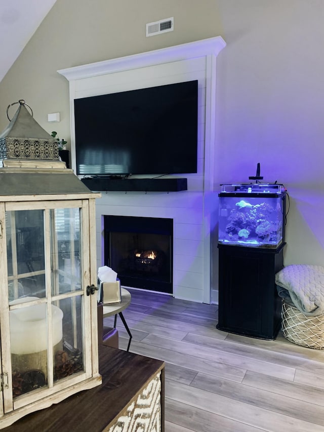 interior space with vaulted ceiling and hardwood / wood-style flooring